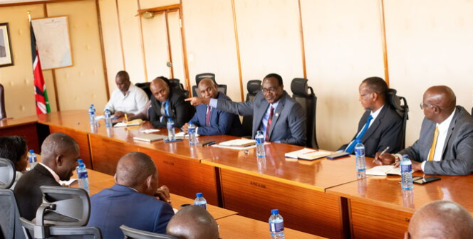 Education CS Julius Ogamba with University union representatives during a meeting.